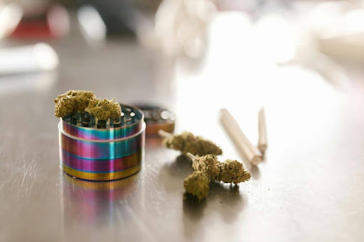 An image of Delta 9 flowers and grinder